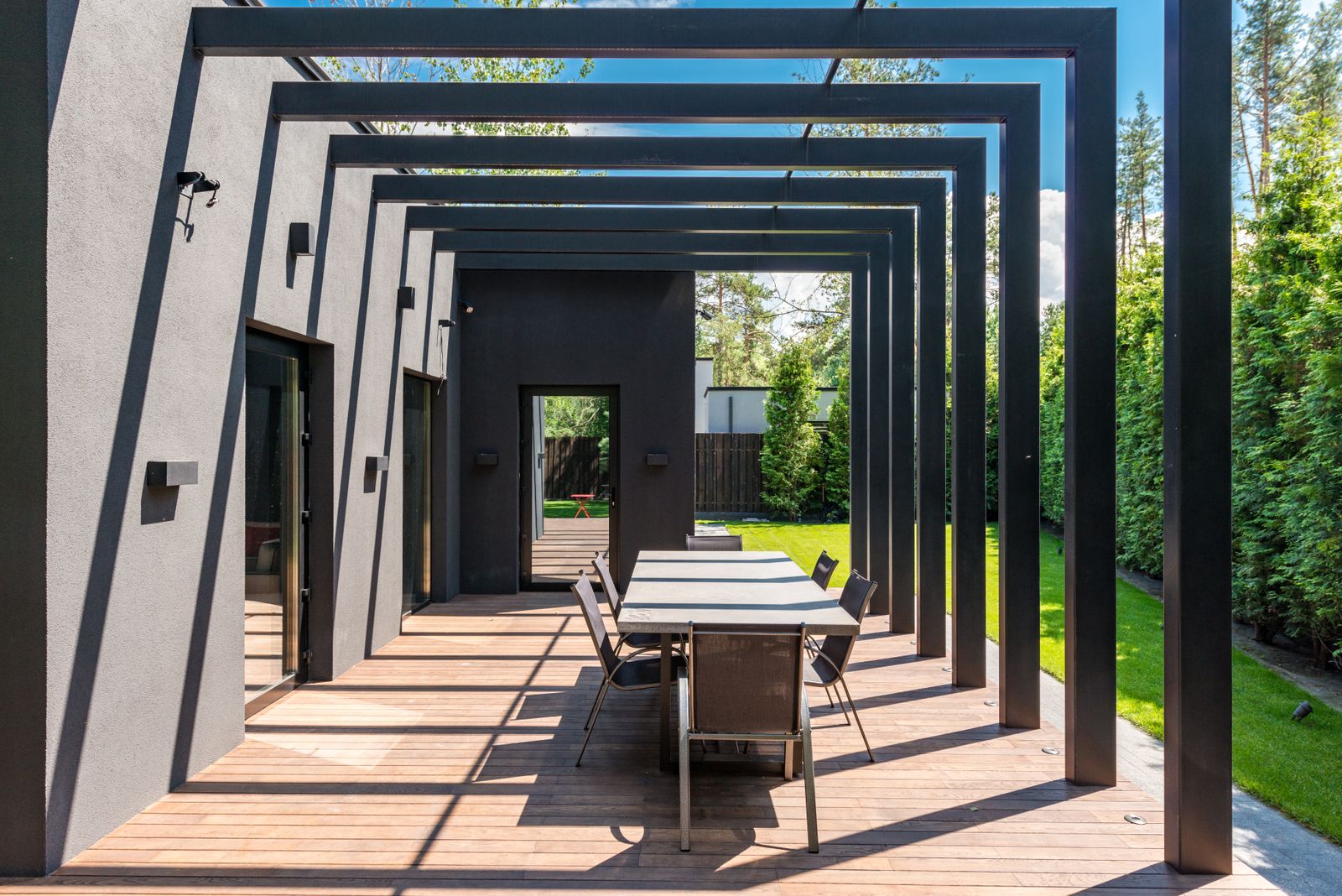 Sunny outdoor dining area beneath a pergola